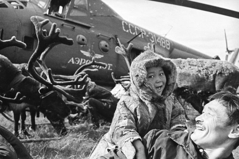 Man and child beside a helicopter, 1965