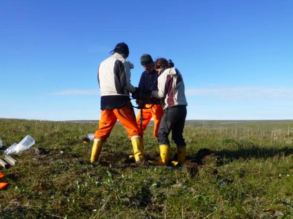 The coring team working to get the core barrel out of the ground which got stuck.
